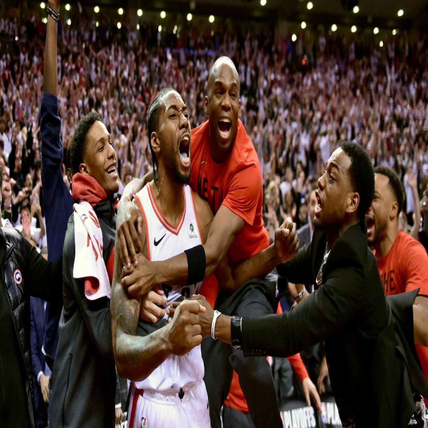 Kawhi Leonard erupts as teammates mob him after a game-winning moment