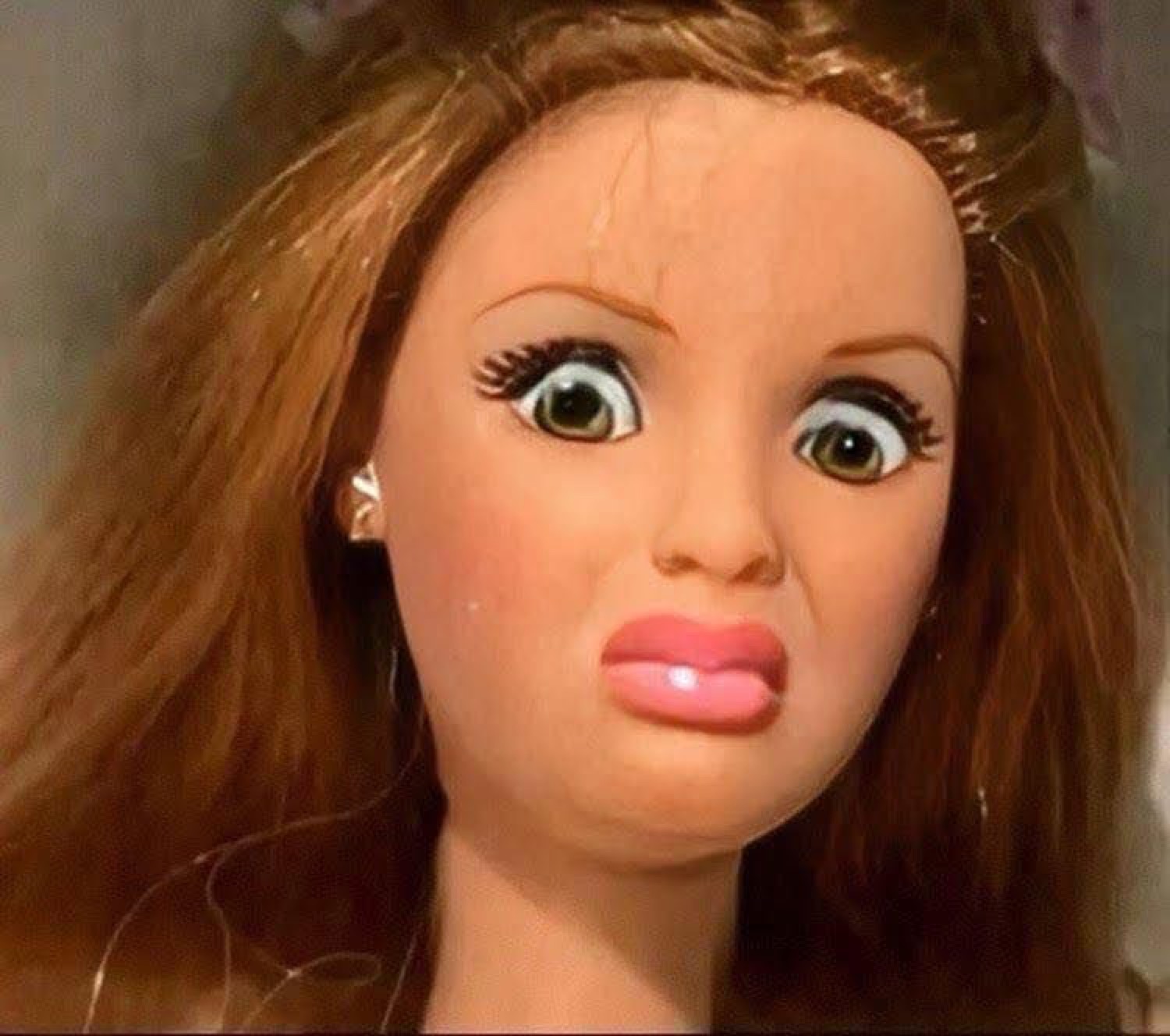 Cracked fashion doll head with huge frozen eyes staring blankly, deeply unsettling
