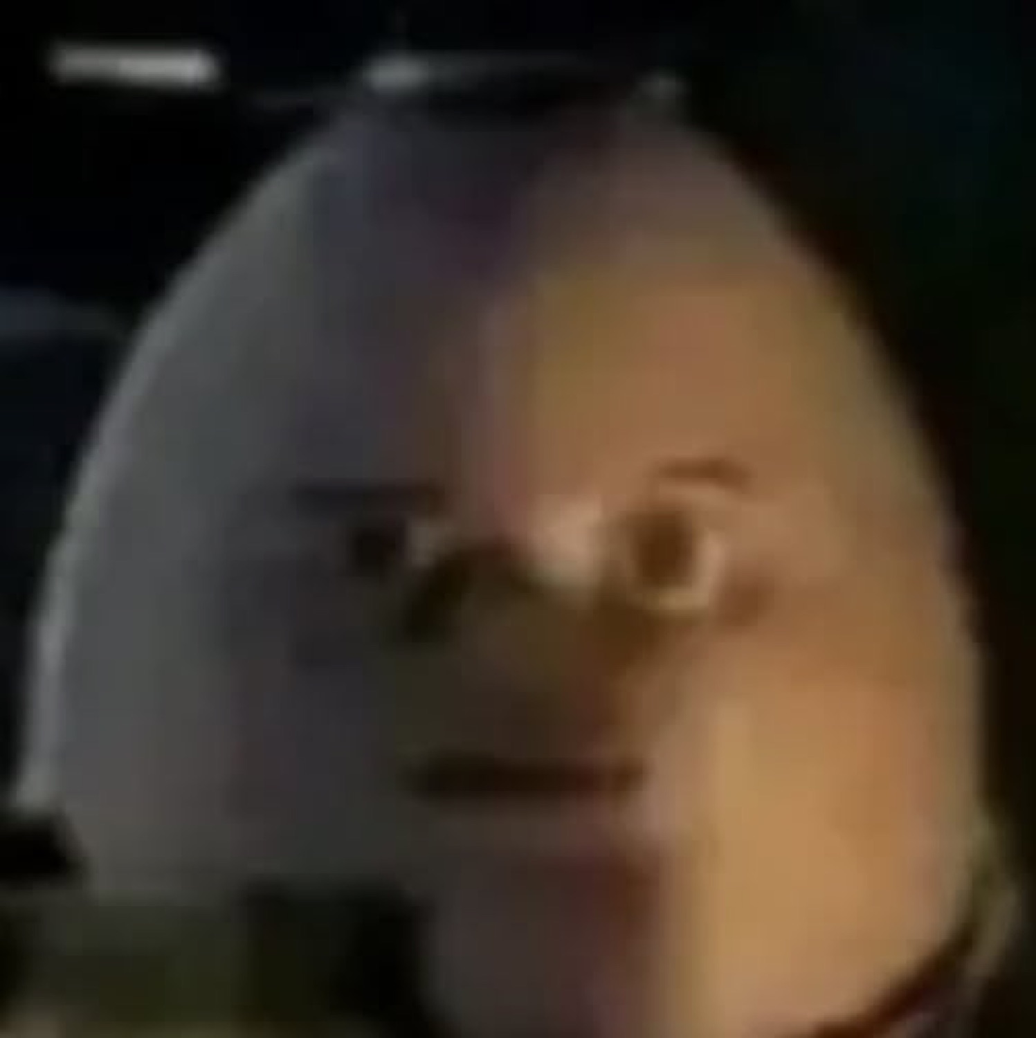 Blurry egg-shaped man with a vacant, unsettling deadpan stare