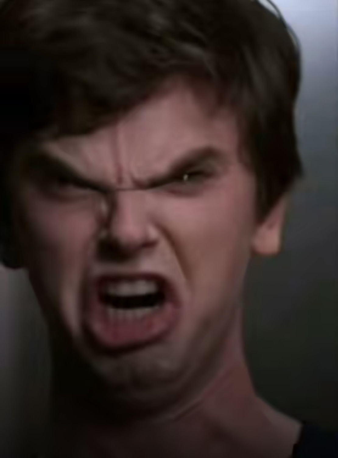 Guy with veins bulging, teeth bared mid-scream in full rage