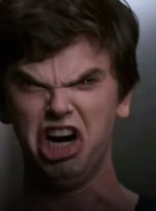 Guy with veins bulging, teeth bared mid-scream in full rage
