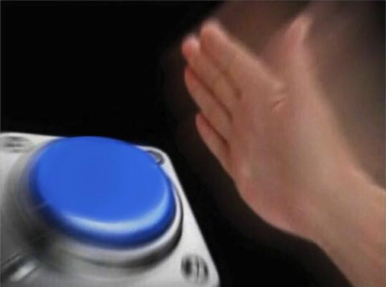 A hand slamming down toward a big blue button in the dark