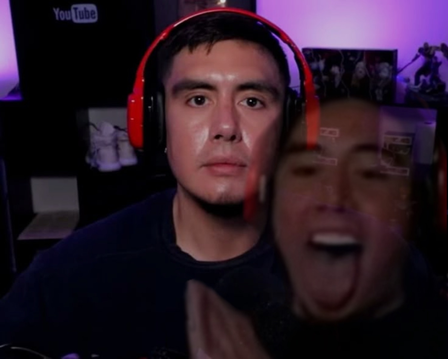 Gamer with red headphones looking calm while chaos erupts behind him