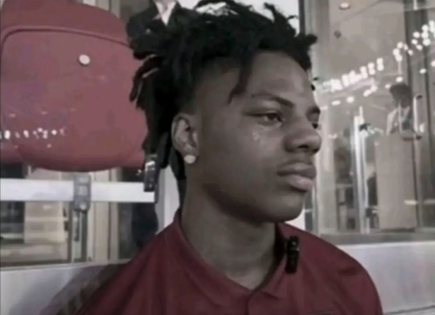 Young man on a train giving an unimpressed, mildly annoyed side glance