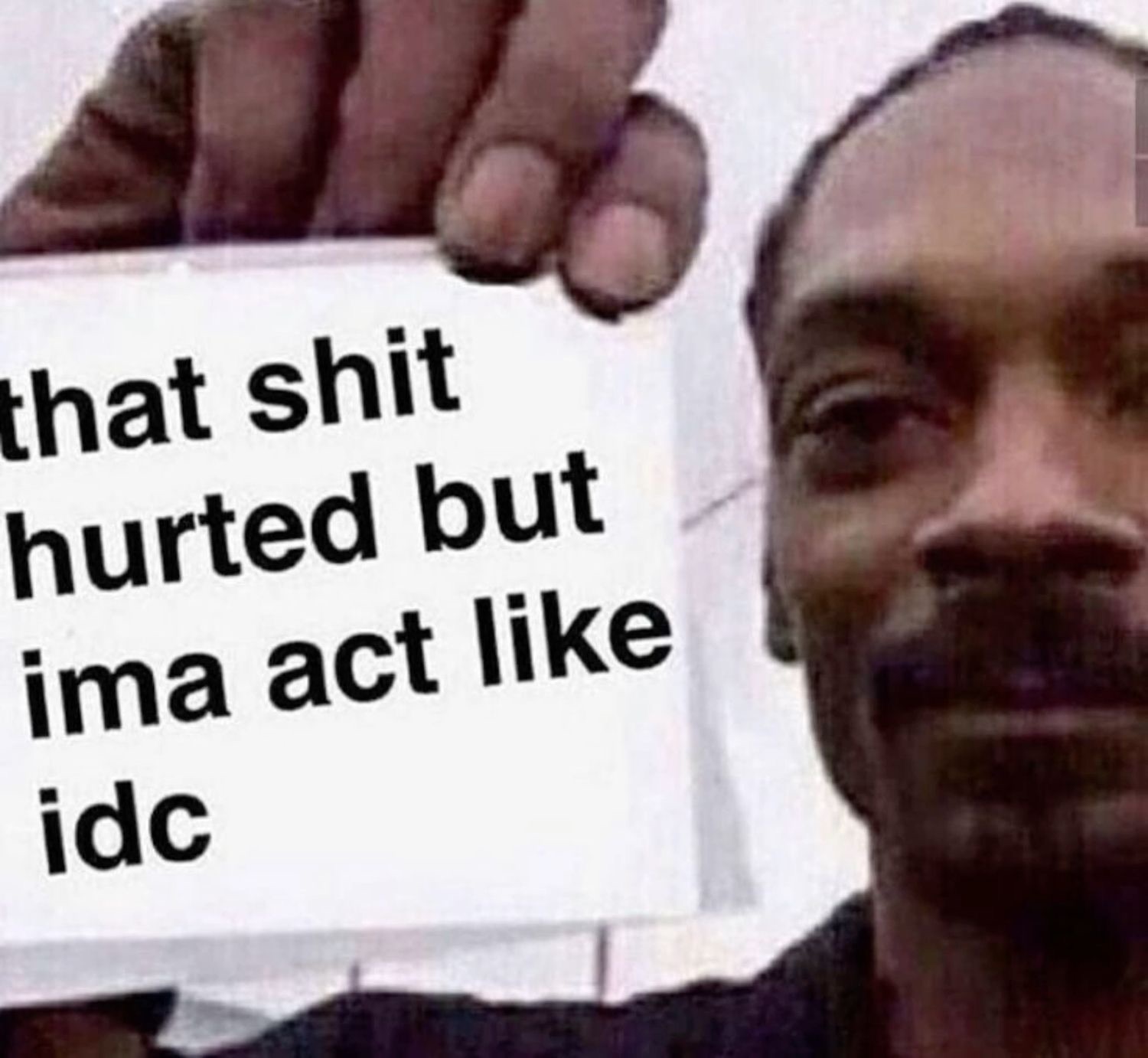 Snoop Dogg holding a sign: 'that shit hurted but ima act like idc'