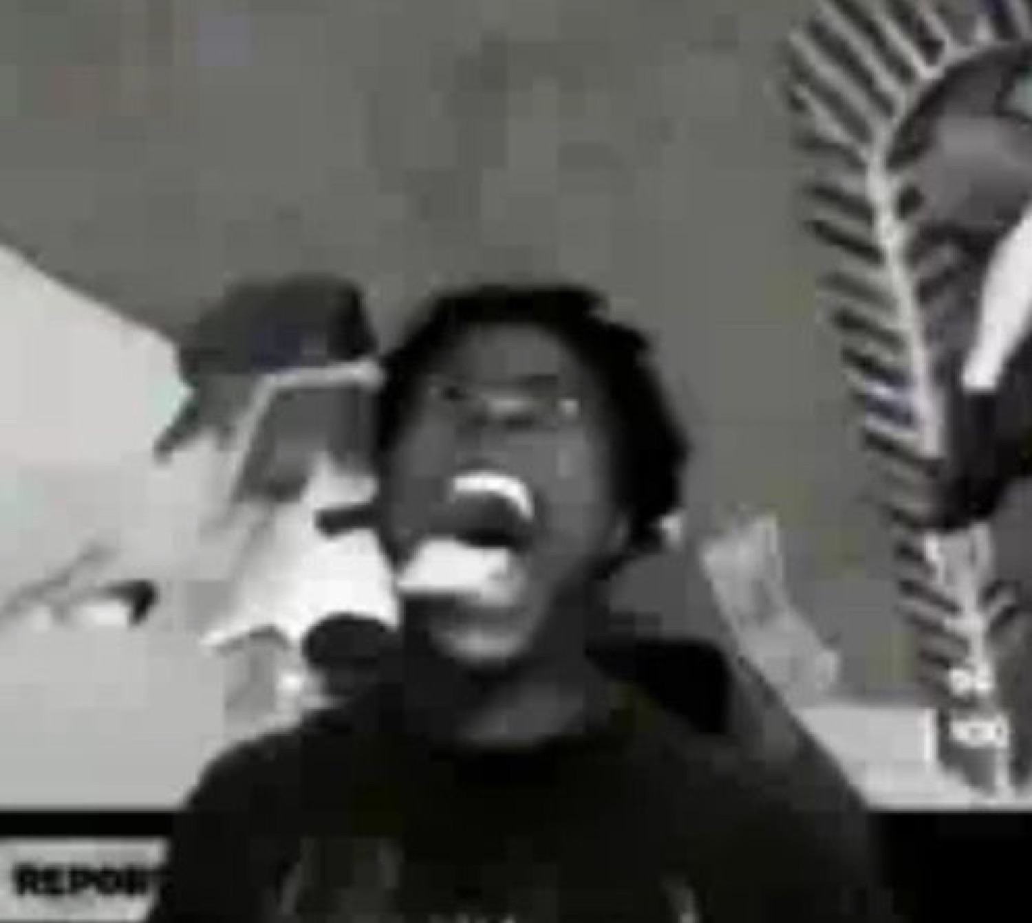 Person screaming at the top of their lungs in a grainy black and white clip
