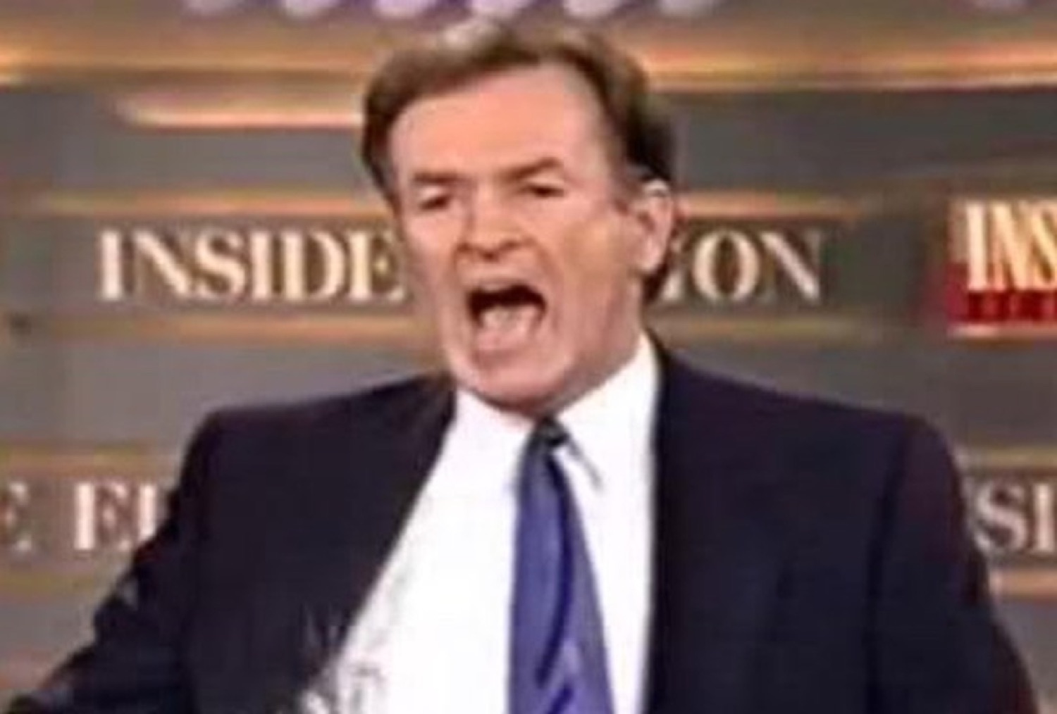 News anchor mid-rant, mouth wide open and furious on an Inside Edition set