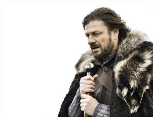 Ned Stark in full winter armor leaning on his sword with a heavy, resigned look