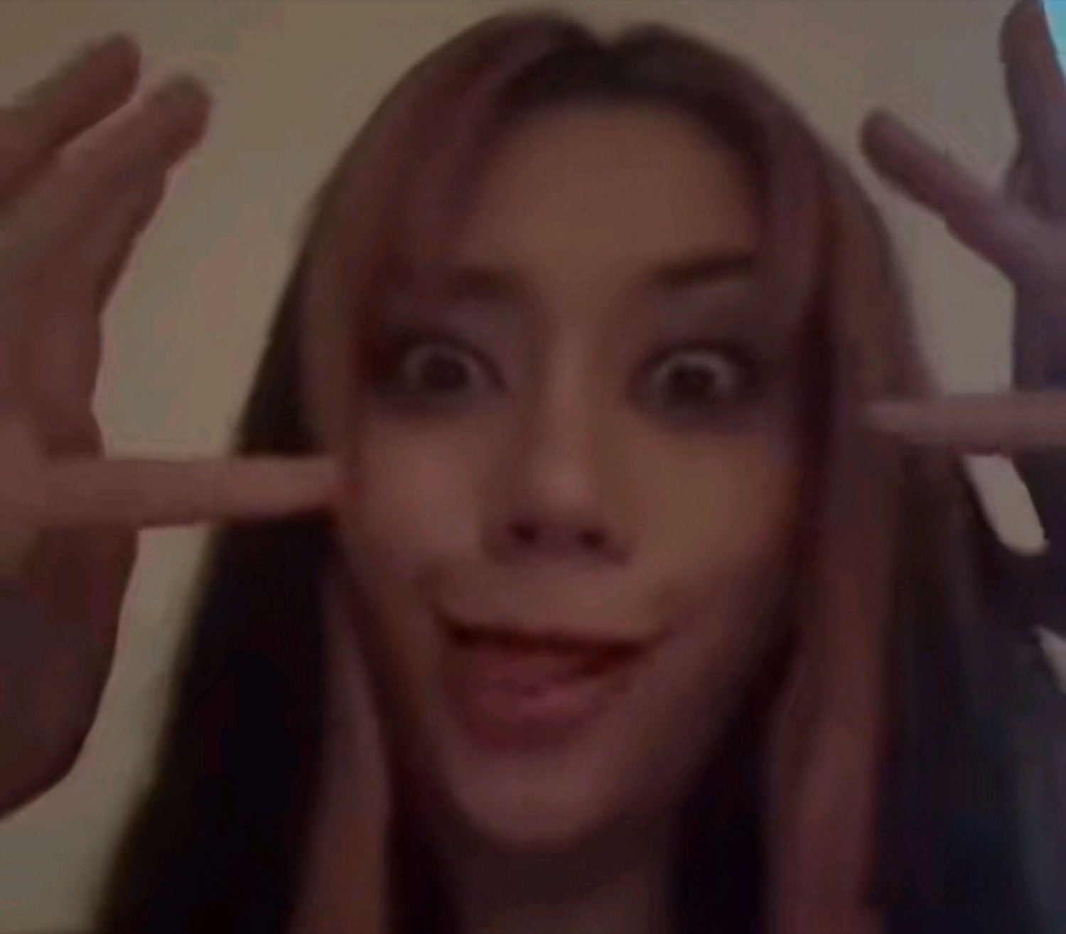 Woman with wide eyes and jazz hands looking thrilled and totally unhinged