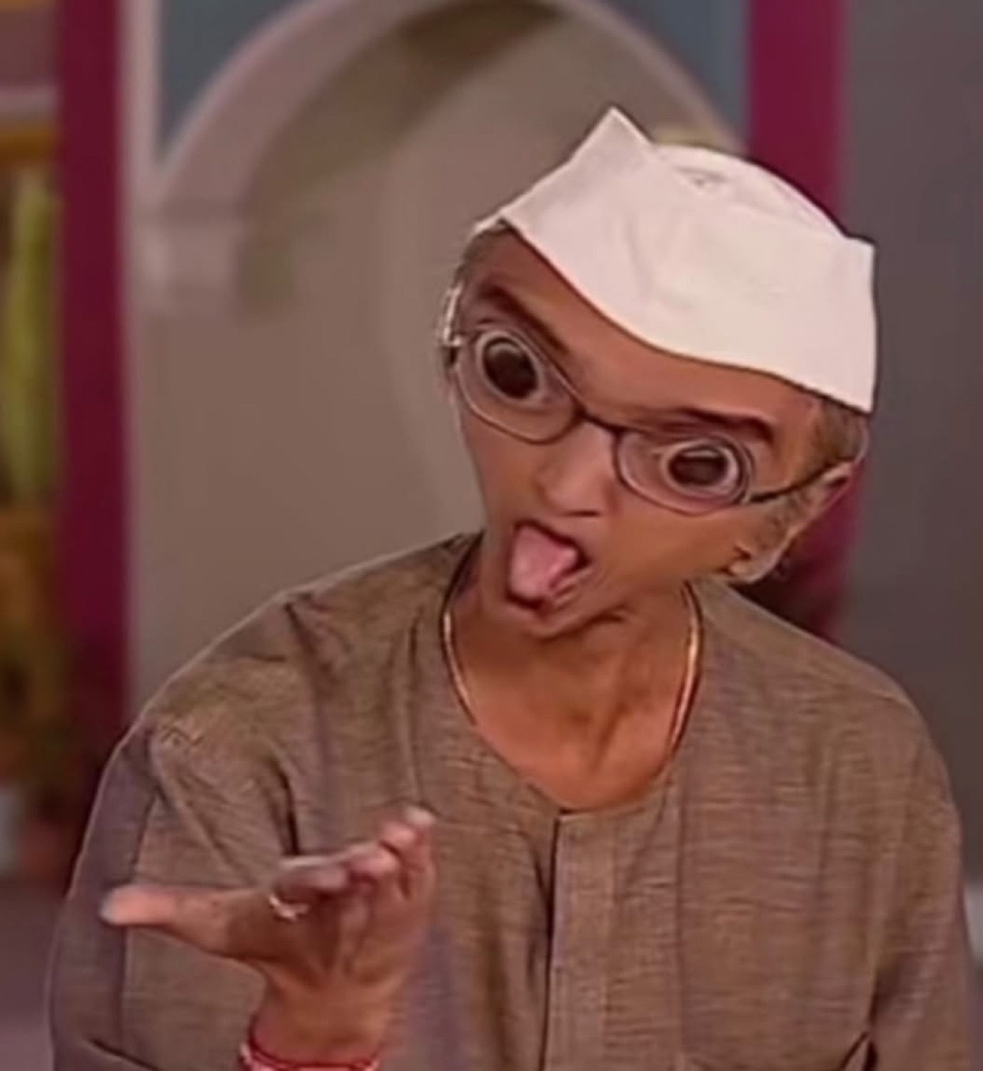 Champaklal from Taarak Mehta sticking his tongue out mid-rant