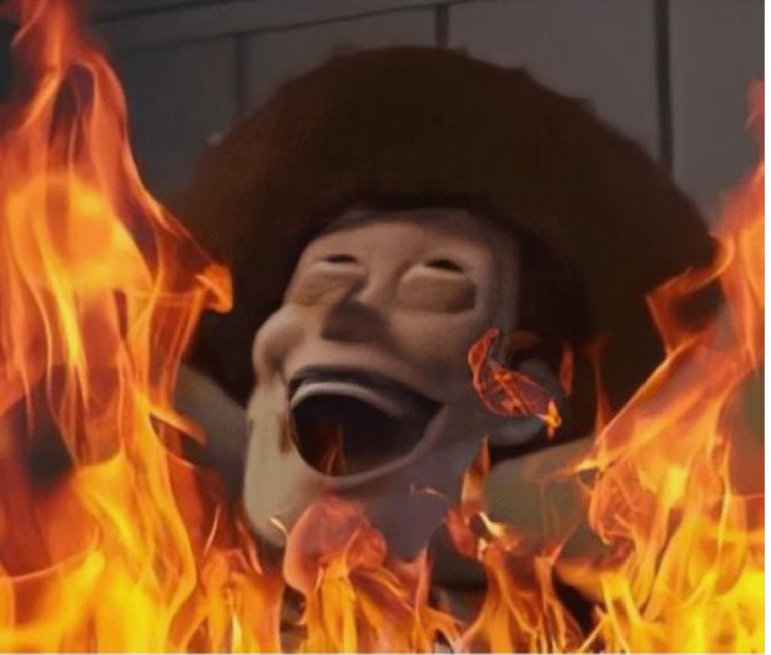 Woody engulfed in flames laughing with his mouth wide open