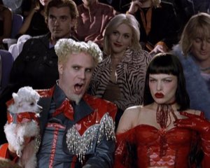 Will Ferrell as Mugatu gasping in the crowd beside a bored woman in red
