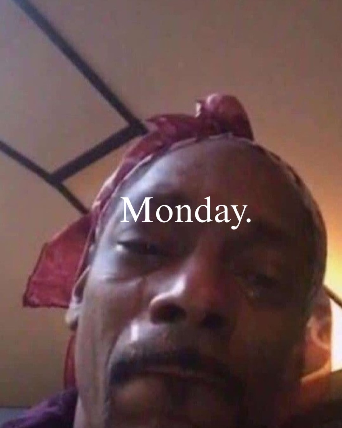 Snoop Dogg in a headscarf looking miserable, captioned 'Monday.'