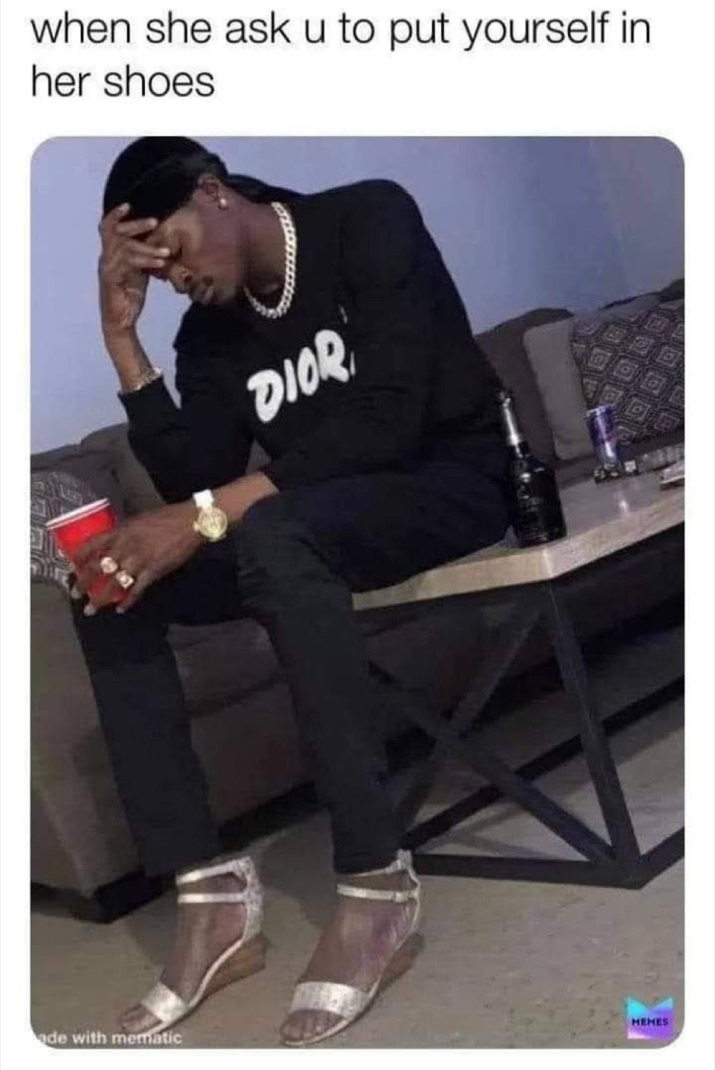 Man in a Dior hoodie with his head in his hand, wearing heels, under 'when she ask u to put yourself in her shoes'