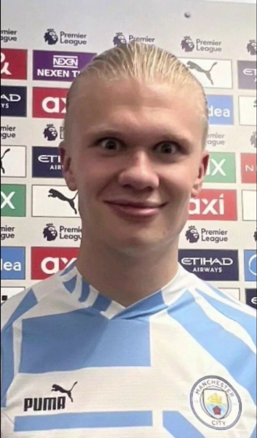 Erling Haaland in a Man City interview flashing a wide, goofy tight-lipped grin