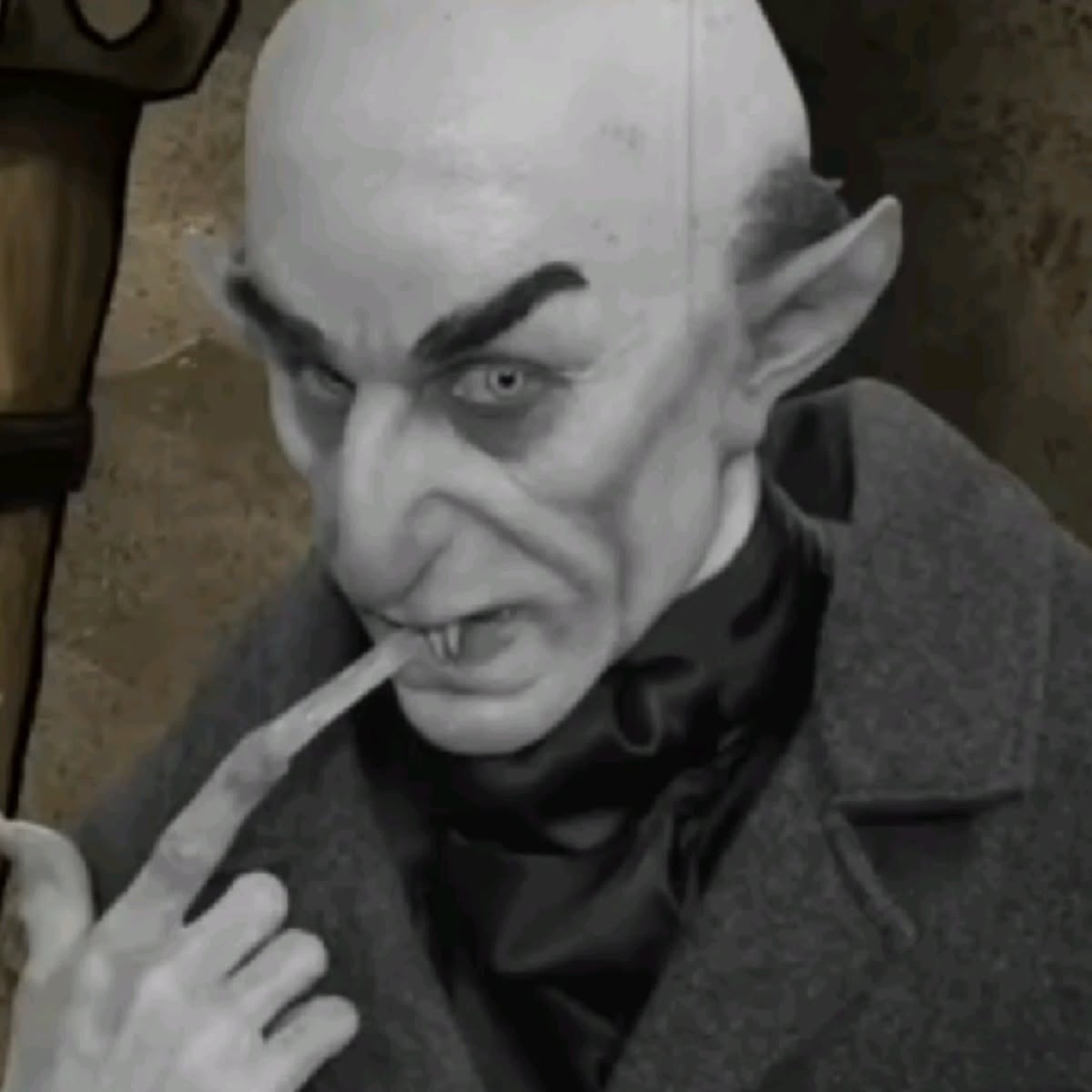 Count Orlok with long nails pressed to his lips, shushing slyly