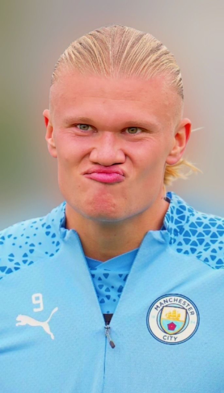 Erling Haaland in a Manchester City kit giving a pouty, unimpressed squint to the camera