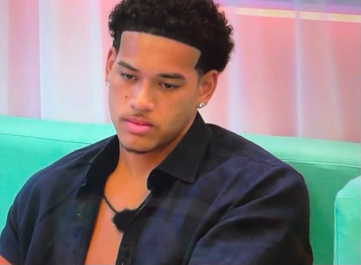 Love Island USA's Corbin looking down with a disappointed face
