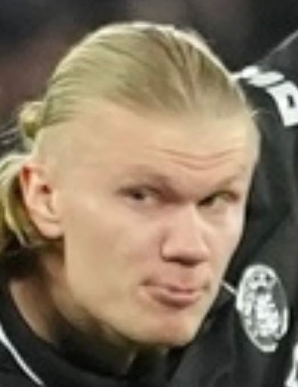 Erling Haaland with a smug, unimpressed pout staring off to the side