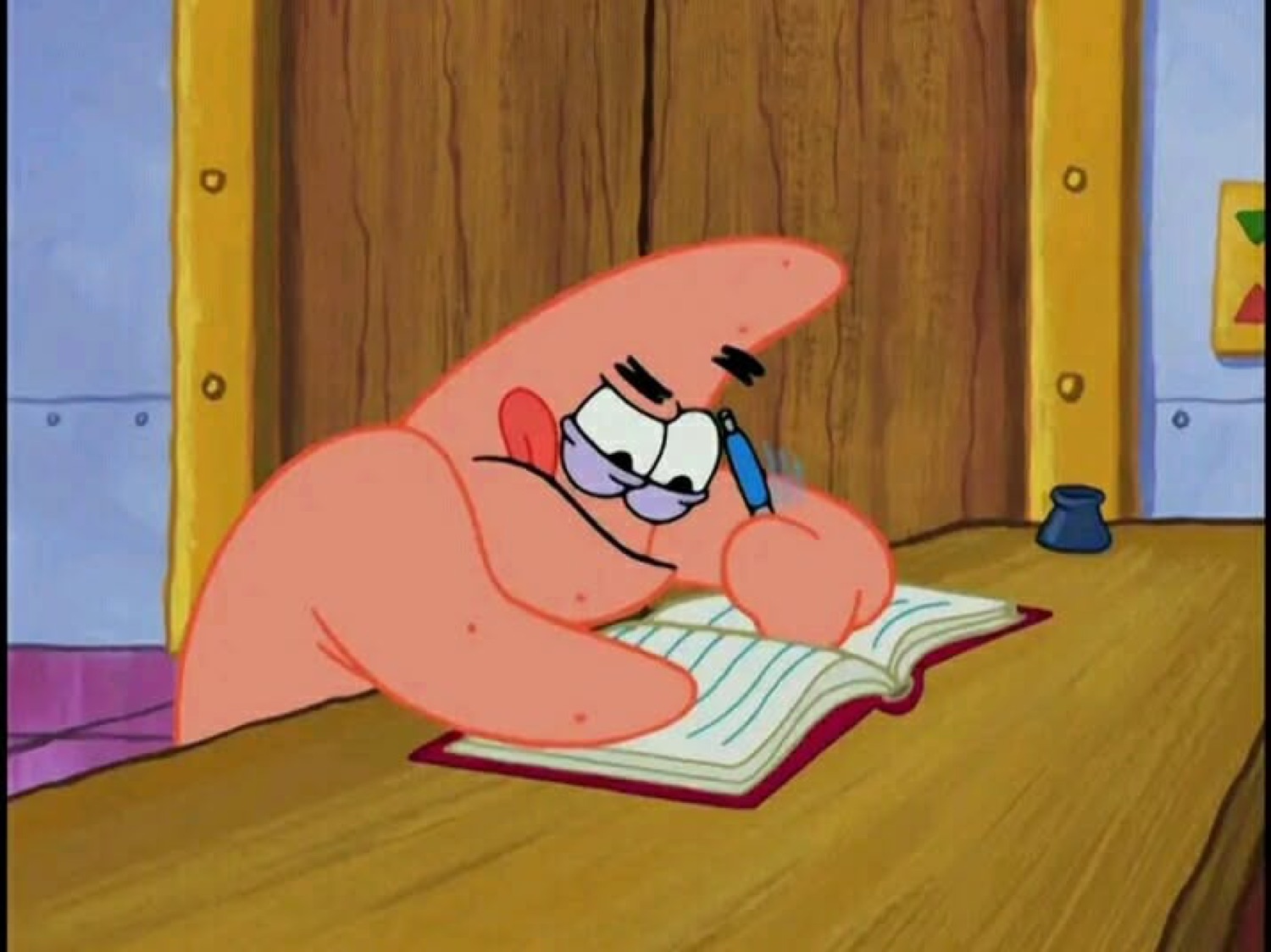 Patrick Star hunched over a book writing