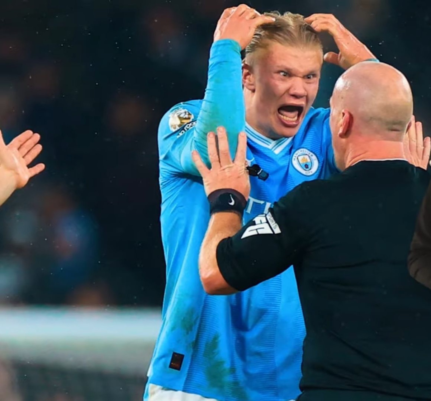Erling Haaland losing his mind in celebration, hands on head, screaming in a Man City kit