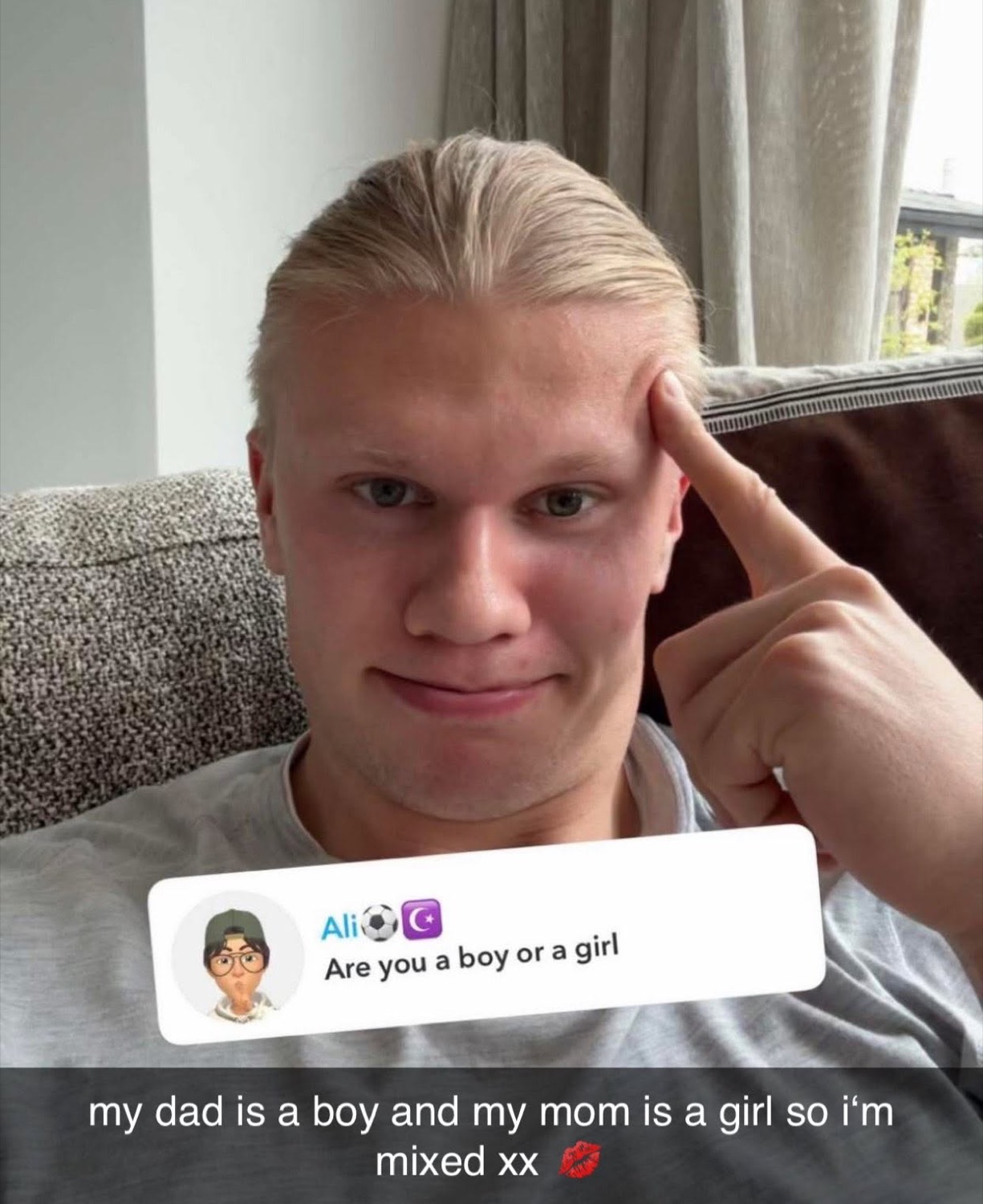 Blond footballer selfie with a finger to his temple answering a DM with 'i'm mixed xx'