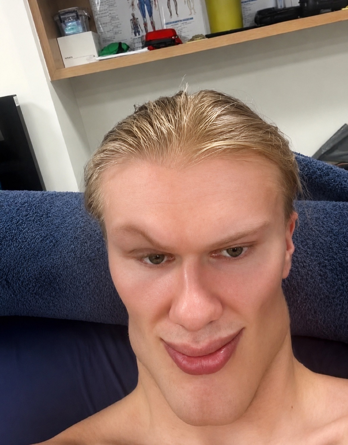 Blond athlete's shirtless selfie leaning back with a smug little smirk