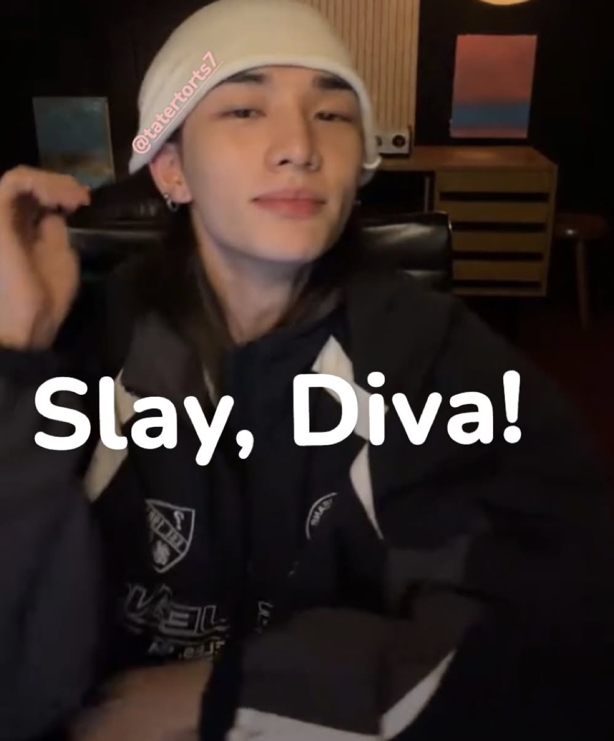 Young man in a white beanie with a calm expression, text 'Slay, Diva!'