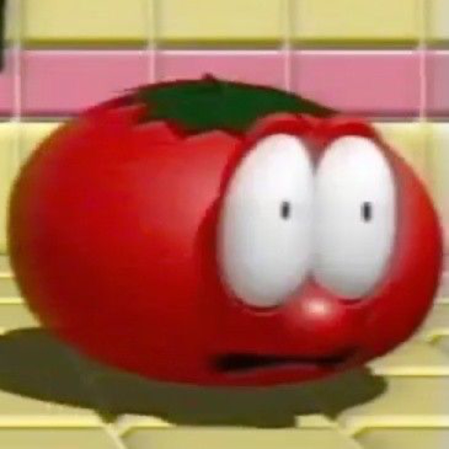 Cartoon tomato with big worried eyes and a slightly open mouth looking startled
