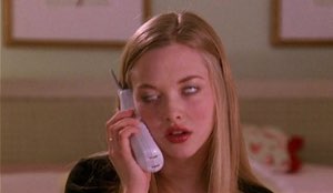 Blonde girl on a cordless phone rolling her eyes with a bored, unbothered look