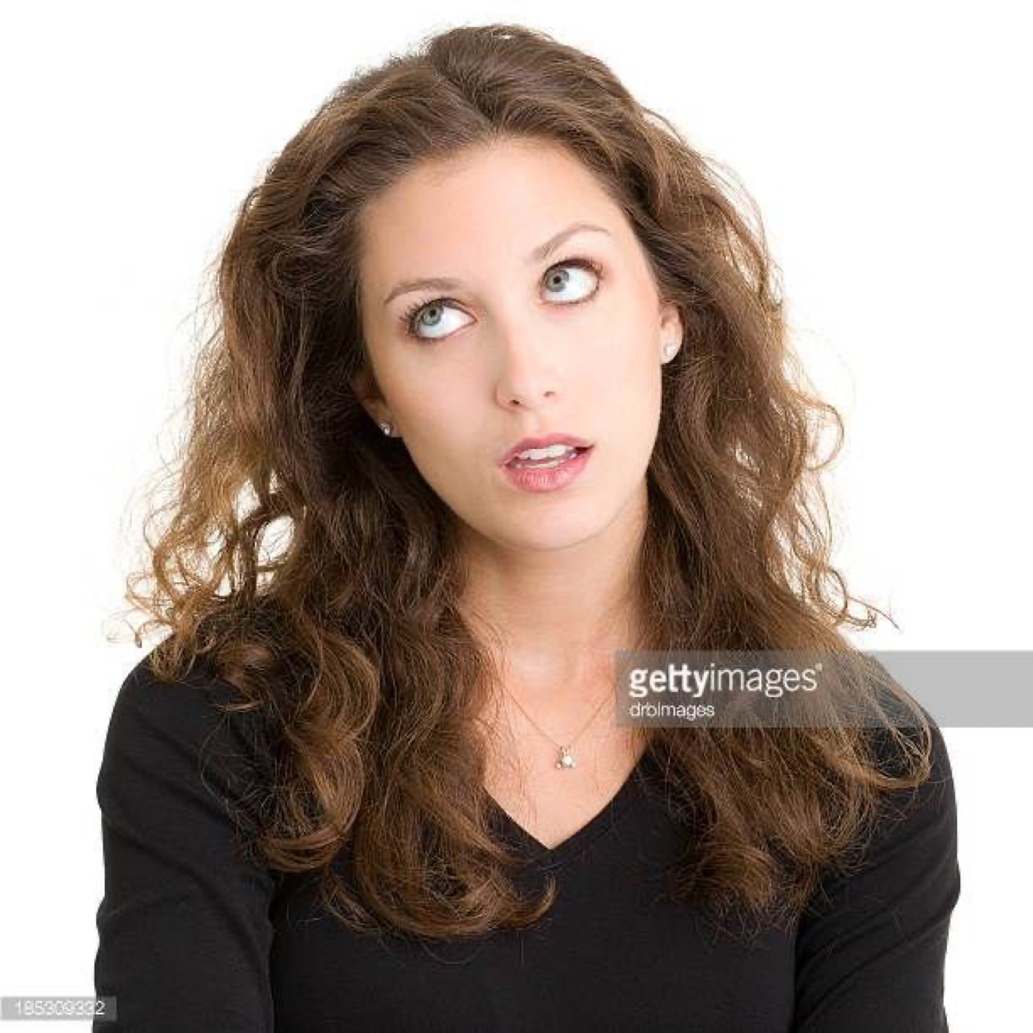 Woman in black glancing sideways with a wary, uneasy look