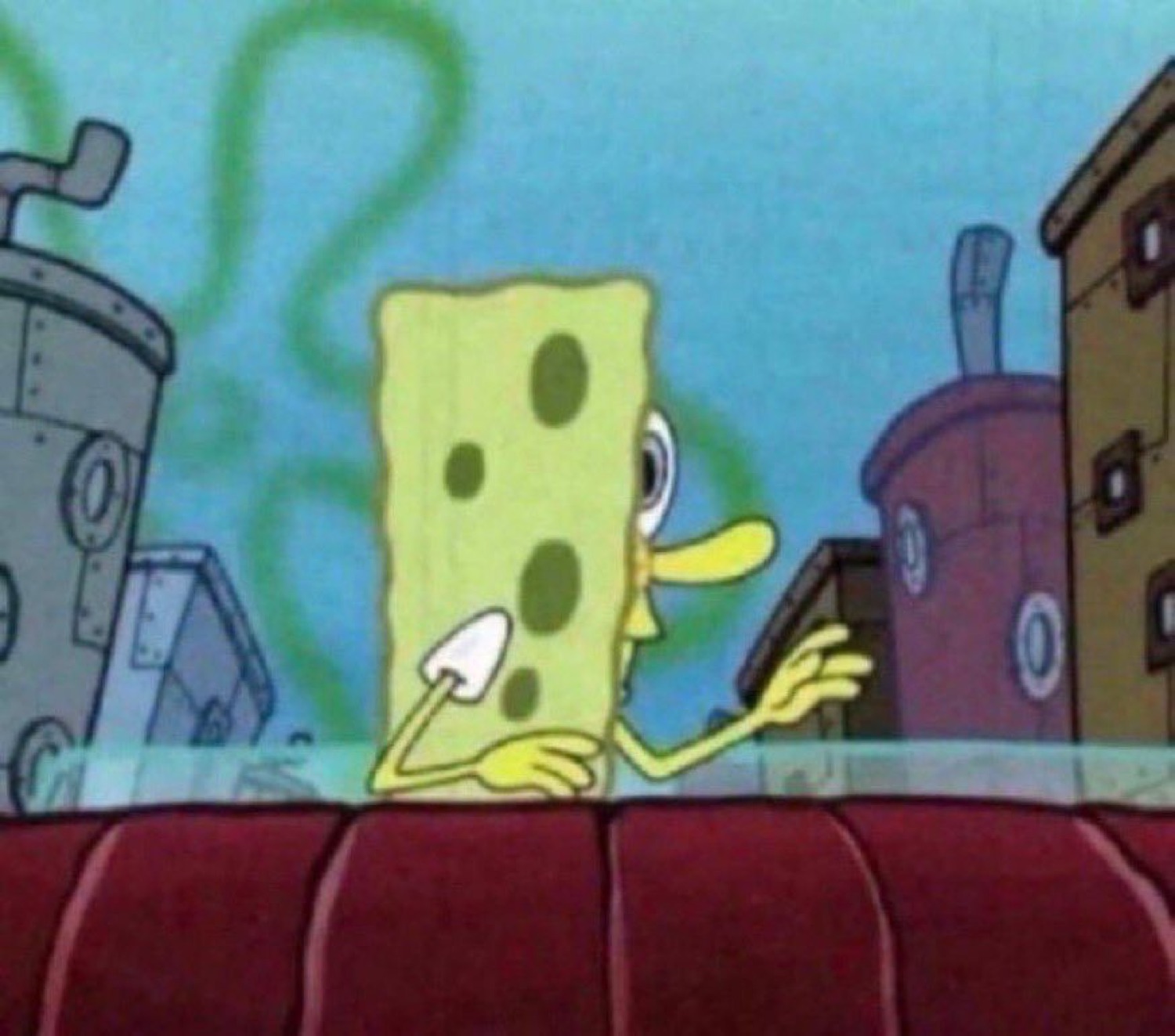 SpongeBob sitting at a counter looking sideways with a flat, unbothered stare