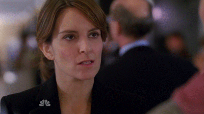 Woman in a dark blazer staring ahead looking completely fed up