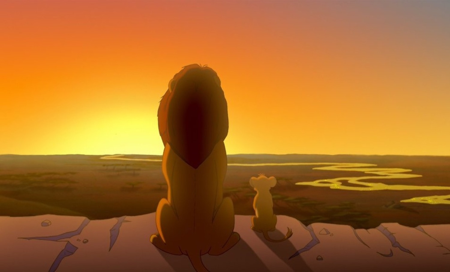 Lion and cub sitting side by side watching a golden sunset over the savanna