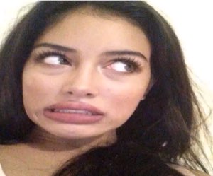 Woman rolling her eyes up with a cringing, disgusted grimace
