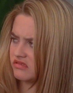 Blonde woman rolling her eyes with a disgusted, over-it expression