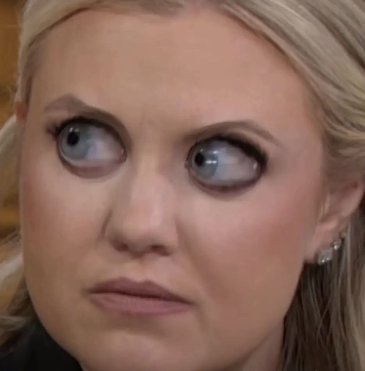 Blonde woman rolling her eyes way over to the side with a doubtful, unimpressed look