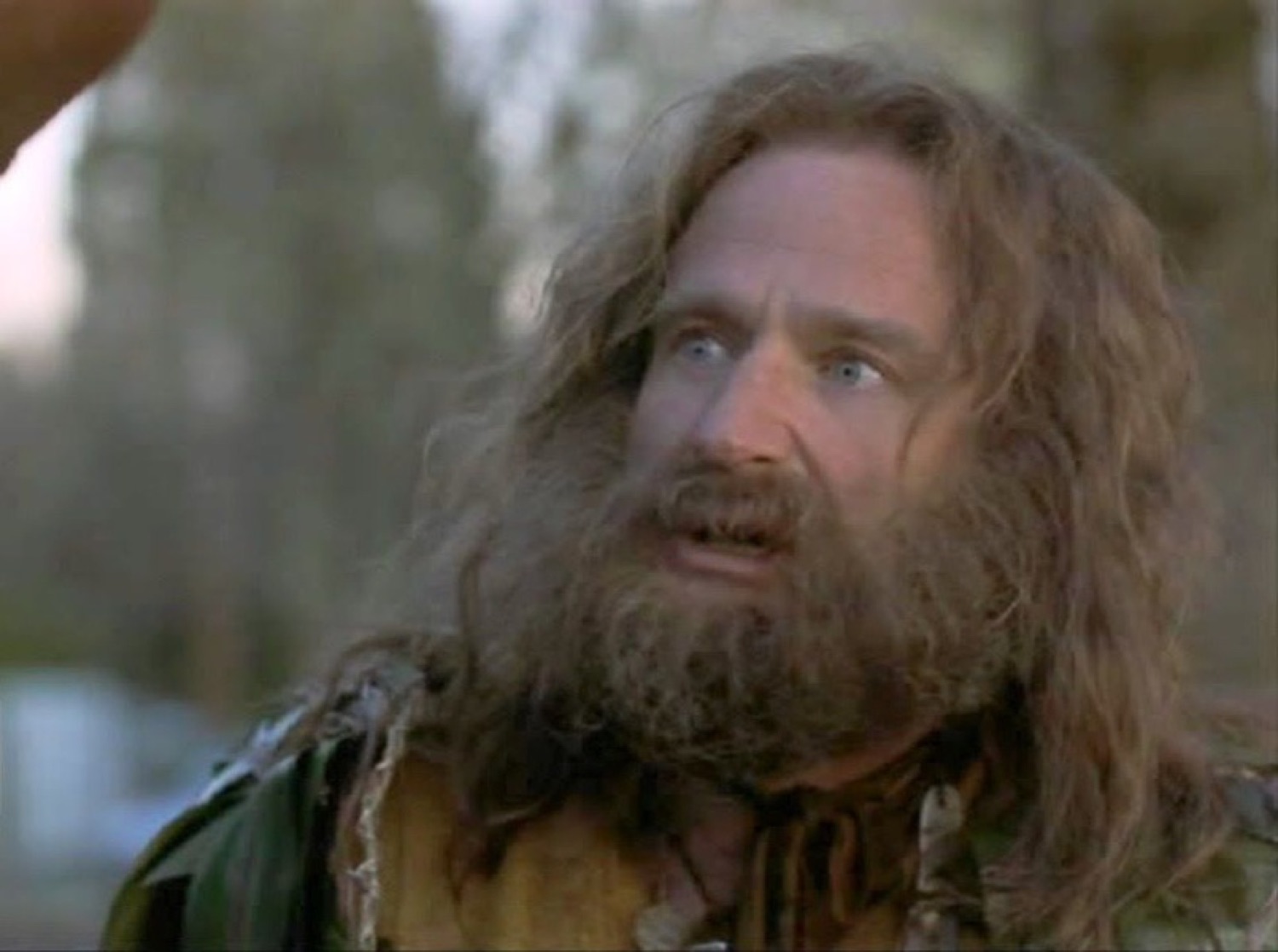 Bearded man with wild hair staring wide-eyed and slack-jawed in disbelief outdoors