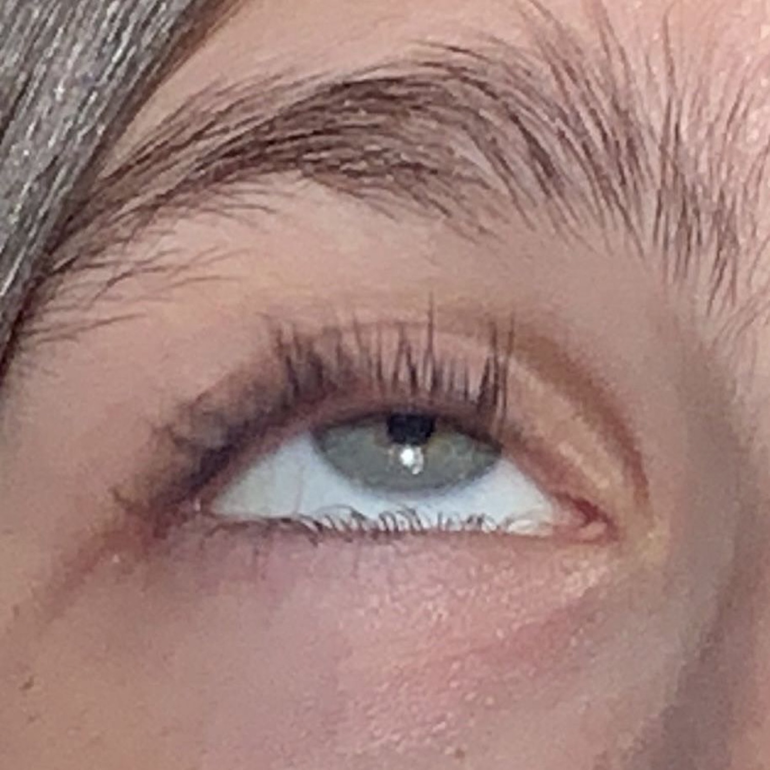 Extreme close-up of a green eye cutting a sideways glance