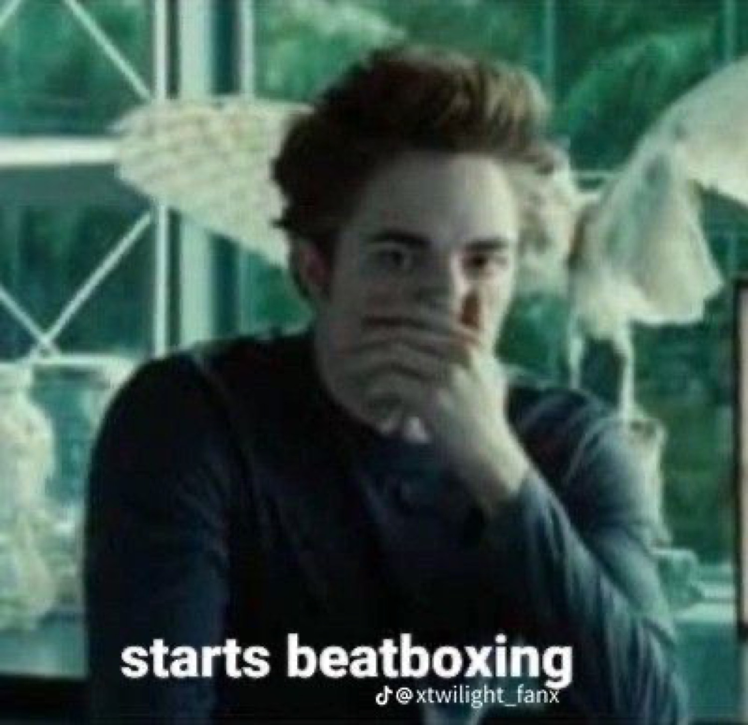 Robert Pattinson in Twilight covering his mouth, captioned 'starts beatboxing'