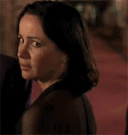 Woman glancing back over her shoulder with a wary, suspicious side-eye