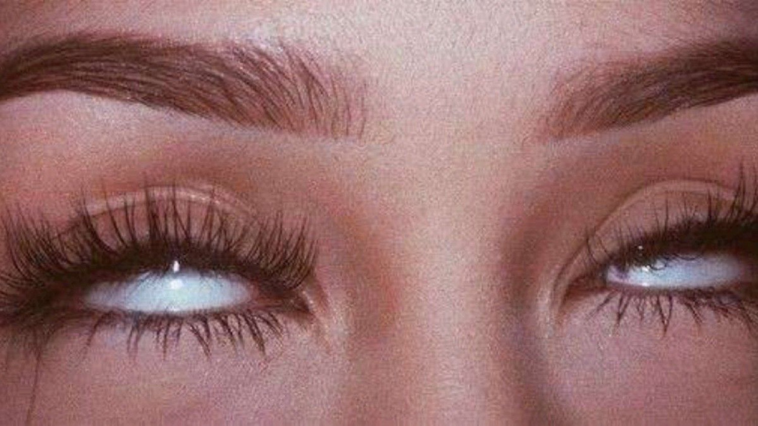 Close-up of eyes rolling all the way back in an exasperated eye-roll