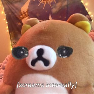 Brown teddy bear plush with drawn-on stressed eyes, captioned '[screams internally]'