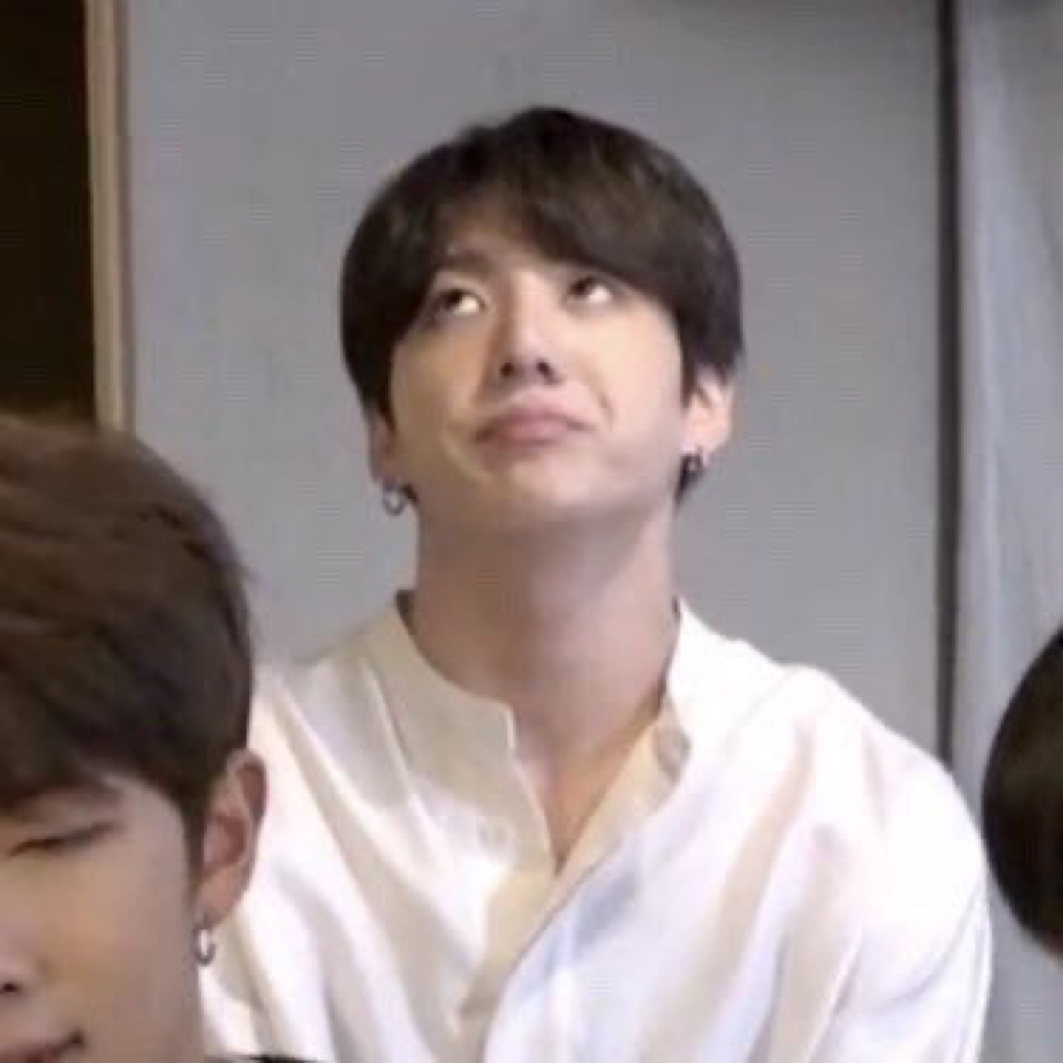 Young man in a white shirt rolling his eyes skyward with barely concealed exasperation