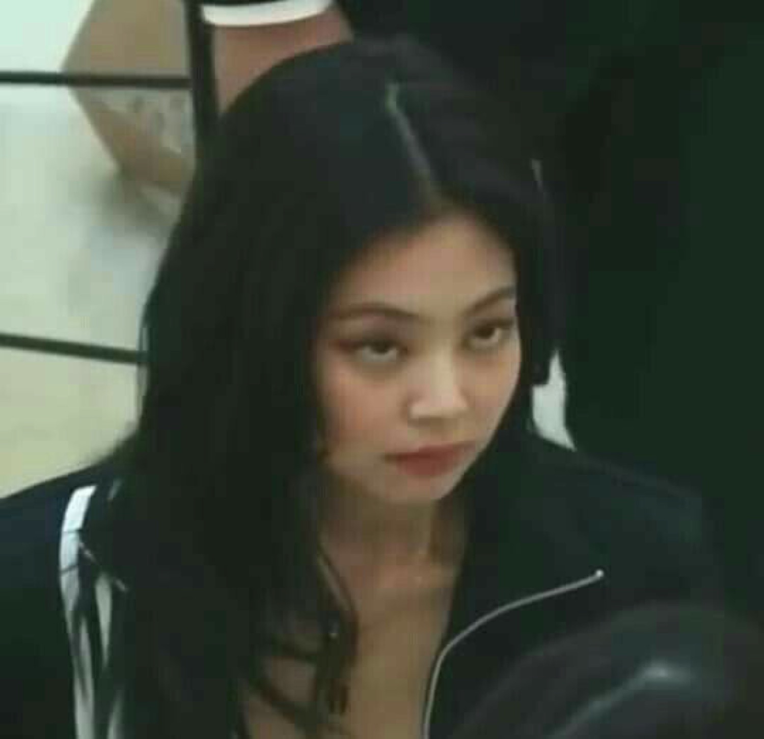 Woman glancing sideways with a cool, unbothered, unimpressed look