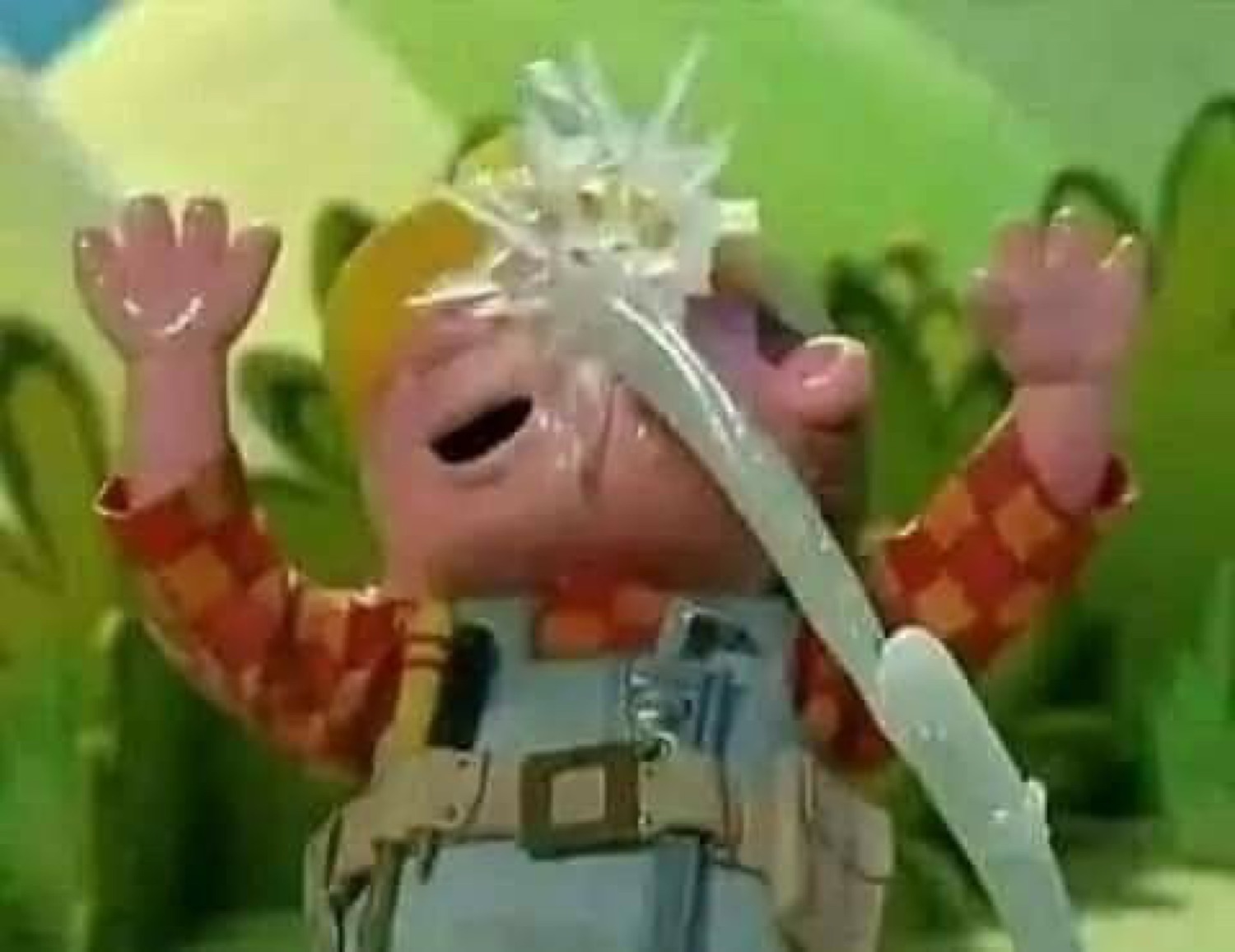 Puppet character getting drenched by water with arms raised in dramatic celebration