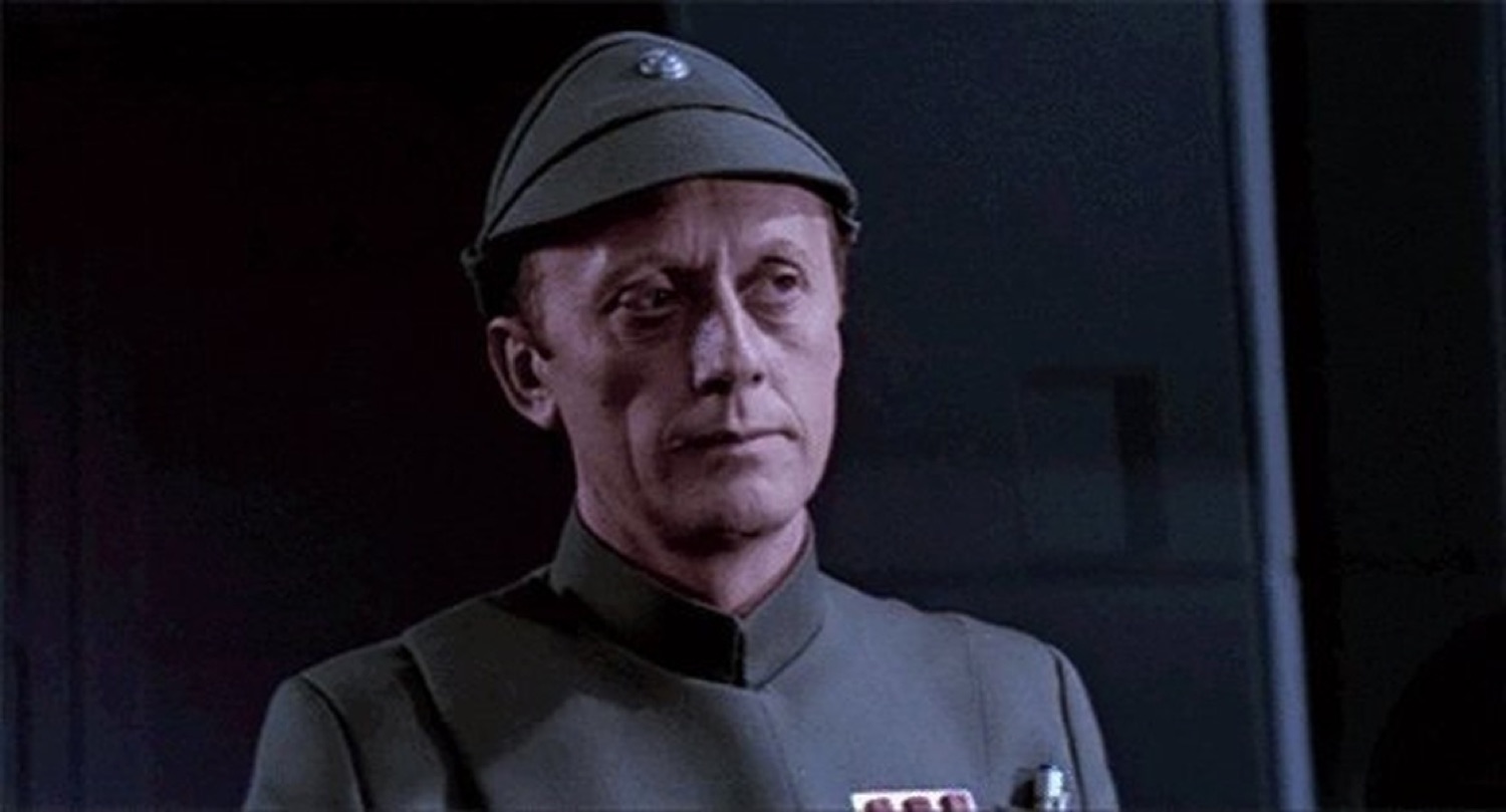 Star Wars Imperial officer staring forward with a stiff, deadpan expression