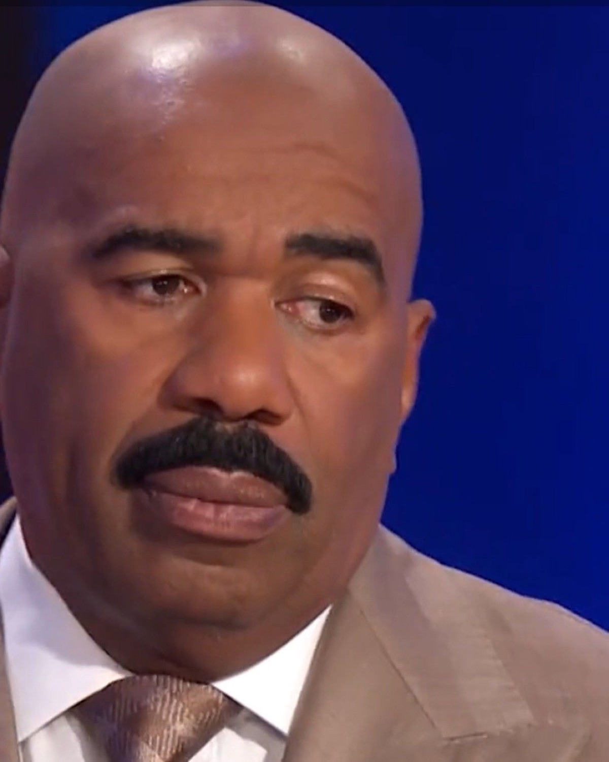 Steve Harvey giving a long, unconvinced side-eye