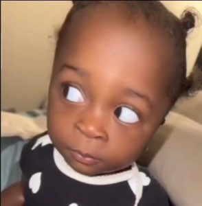 Baby cutting a serious side-eye across the room with clear judgment