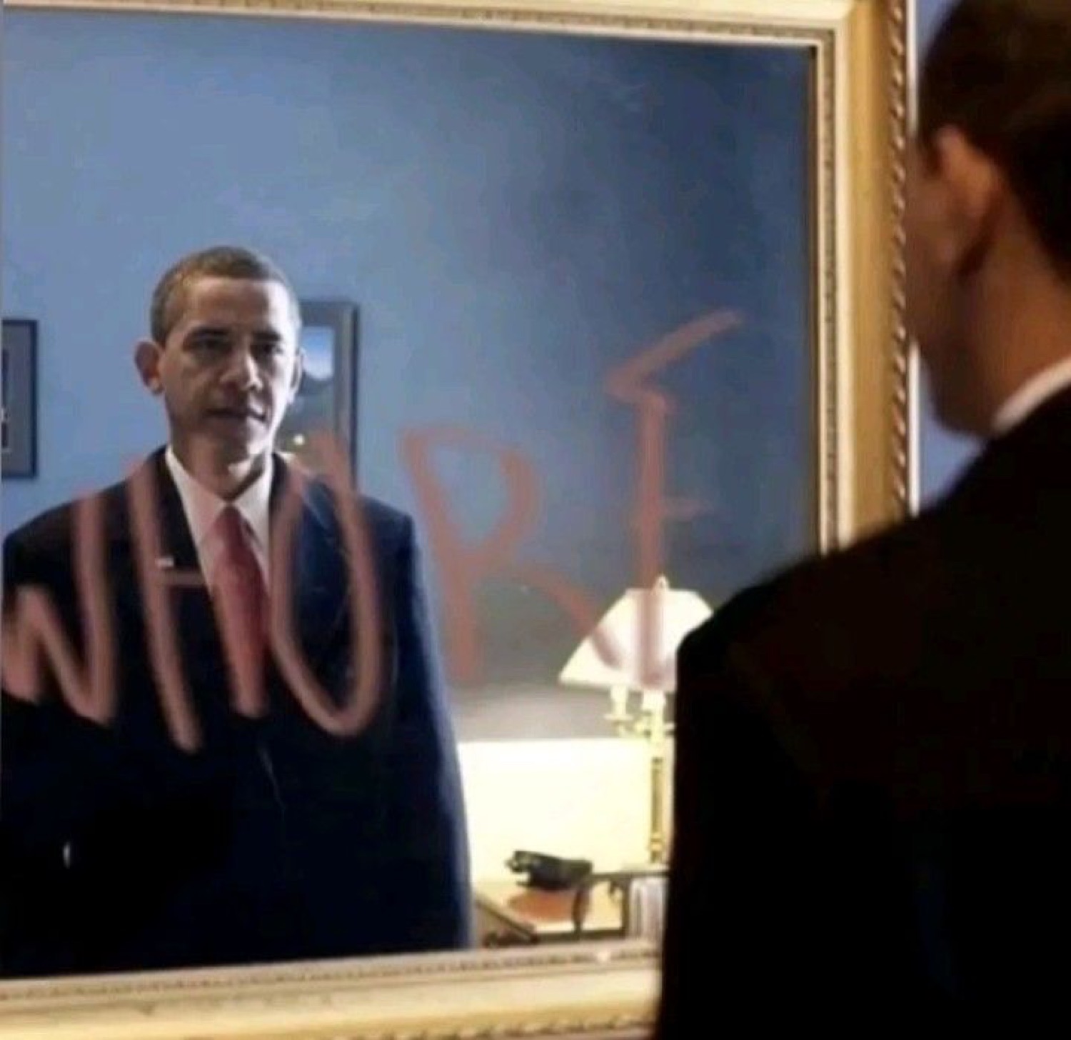 Obama's reflection in a mirror with graffiti-style text scrawled across it